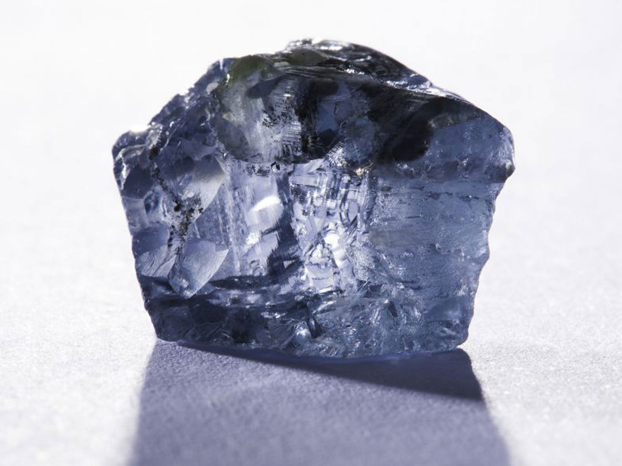 This handout picture released by the Petra Diamonds company website on January 21, 2014 and taken on January 18, 2014 shows a 29,6 carat blue diamond, worth several million dollars, which was found in January 2014 in the Cullinan mine near Pretoria.
