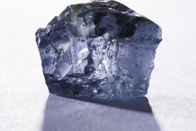 This handout picture released by the Petra Diamonds company website on January 21, 2014 and taken on January 18, 2014 shows a 29,6 carat blue diamond, worth several million dollars, which was found in January 2014 in the Cullinan mine near Pretoria. 