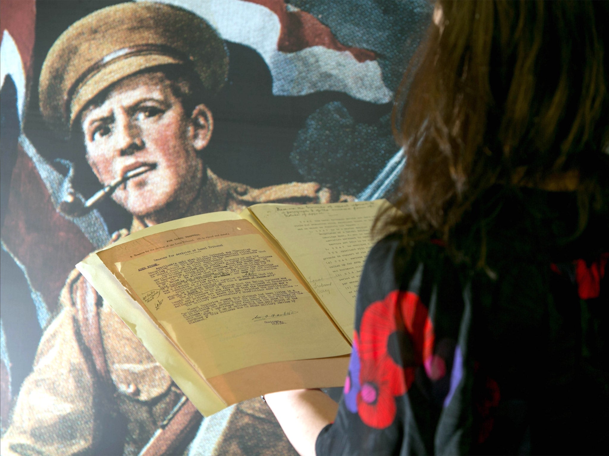 A woman looks at tribunal records from WW1 at the National Archives in Kew, west London