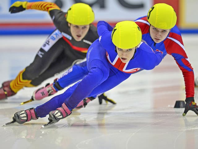 Elise Christie of Great Britain (centre) competes in an ISU speed skating event