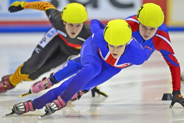 Elise Christie of Great Britain (centre) competes in an ISU speed skating event