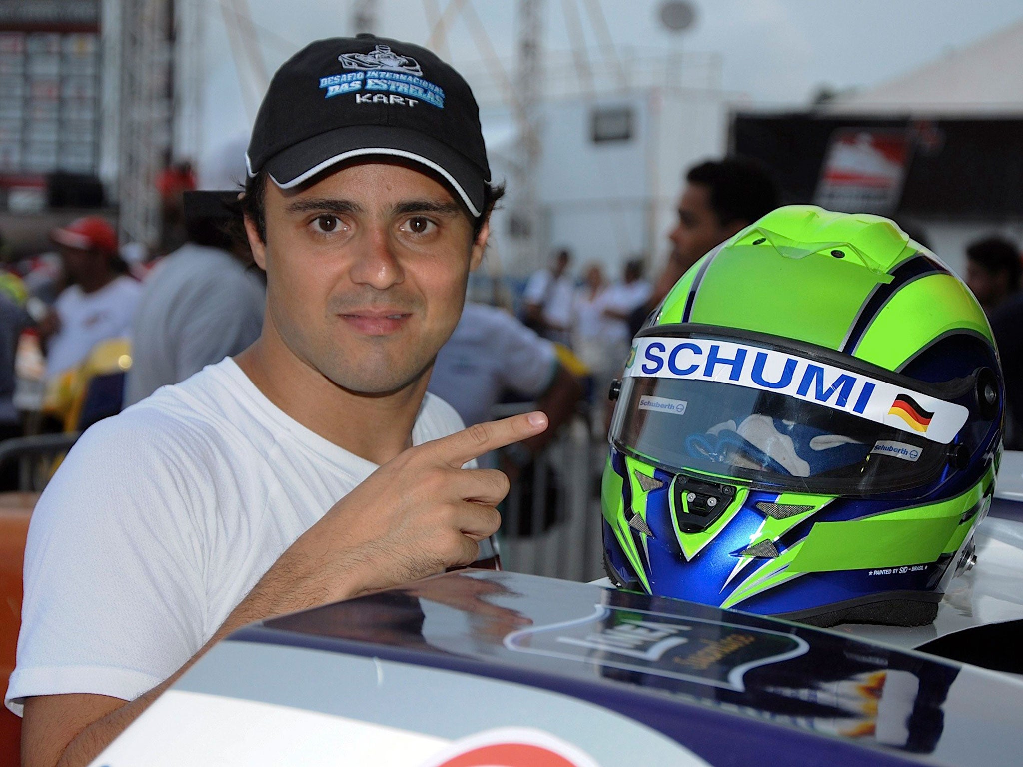 Felipe Massa paid tribute to his former team-mate Michael Schumacher during his annual charity karting race in Brazil by wearing 'Schumi' across his visor