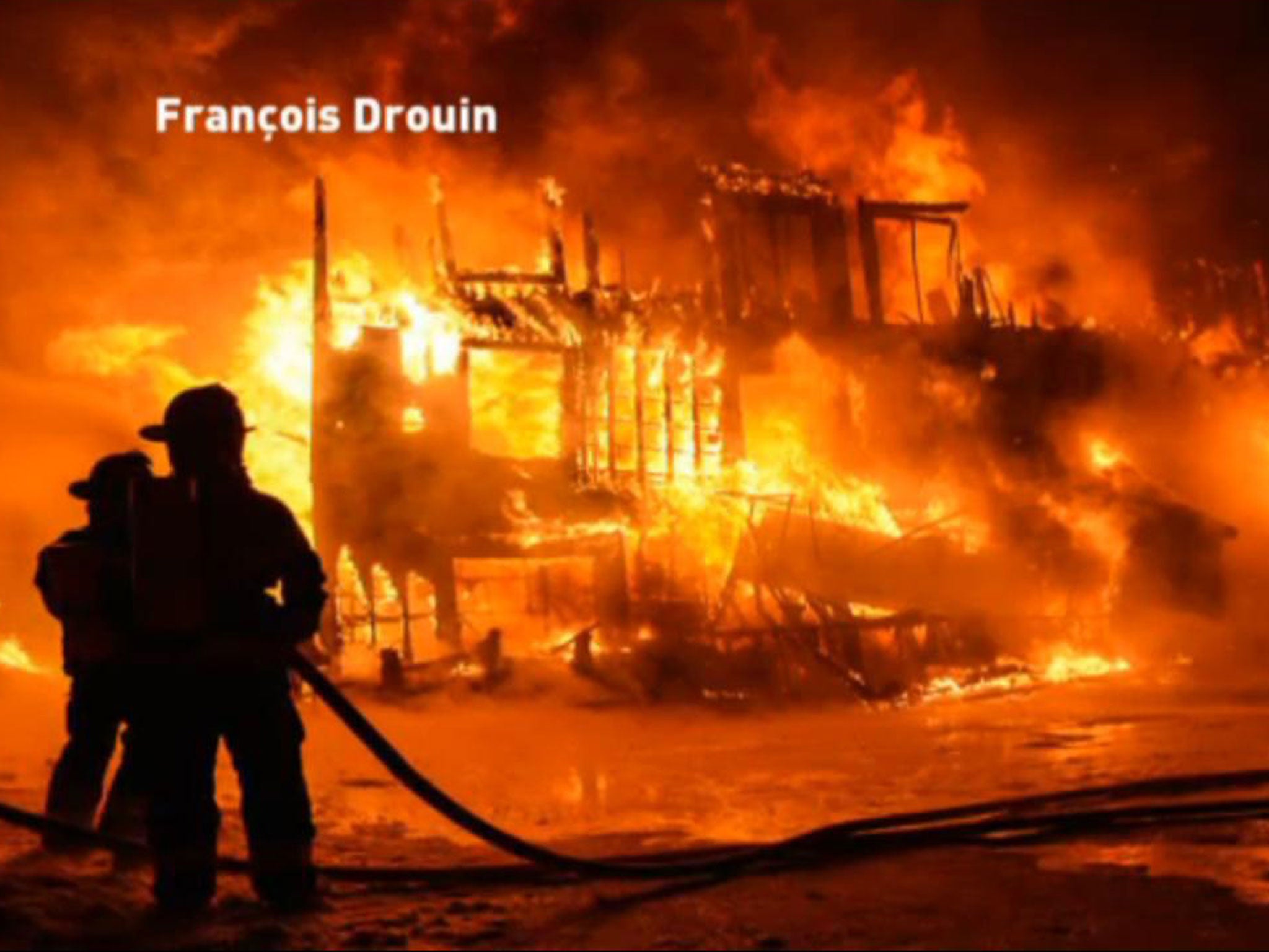 The fire as it took hold of the building in Quebec