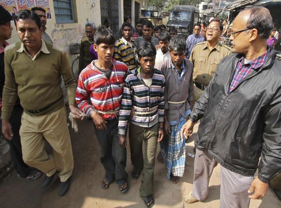 Indian police escort men accused of a gang-rape to a court at Birbhum district 