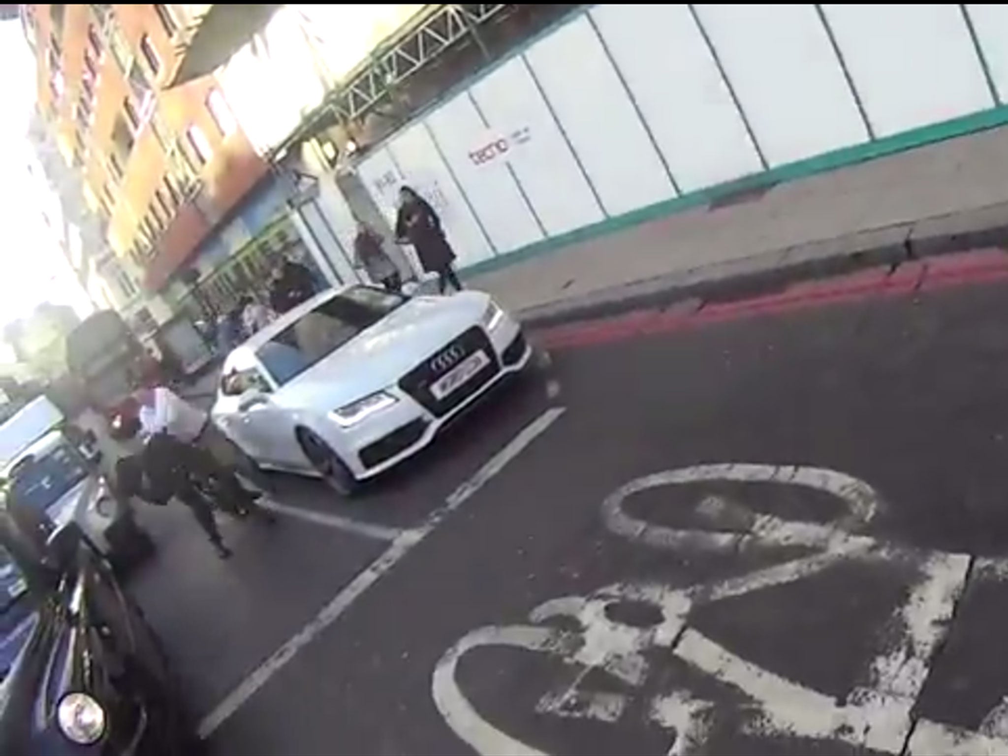 A still from footage appearing to show a cyclist allegedly being hit in the face by a car passenger in Farringdon, London