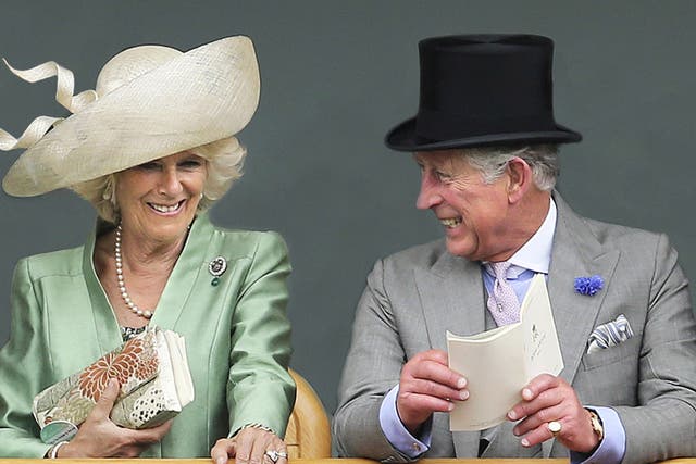Camilla, Duchess of Cornwall and Prince Charles, Prince of Wales as they are seen viewing horses in the parade ring from the Royal Box on the second day of Royal Ascot in London, 2013