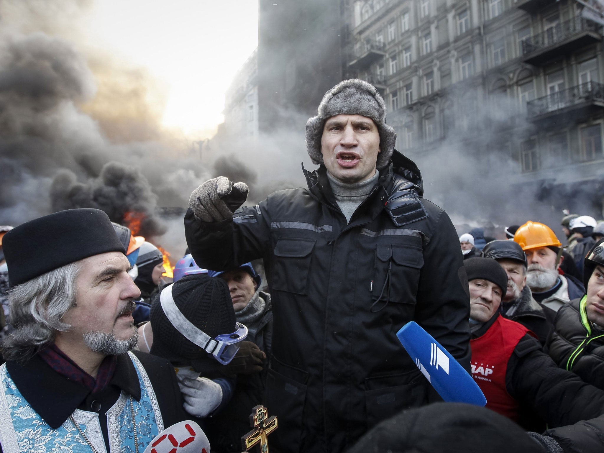 Opposition leader Vitaly Klitschko talks with pro-European integration protesters at the site of clashes with riot police in Kiev