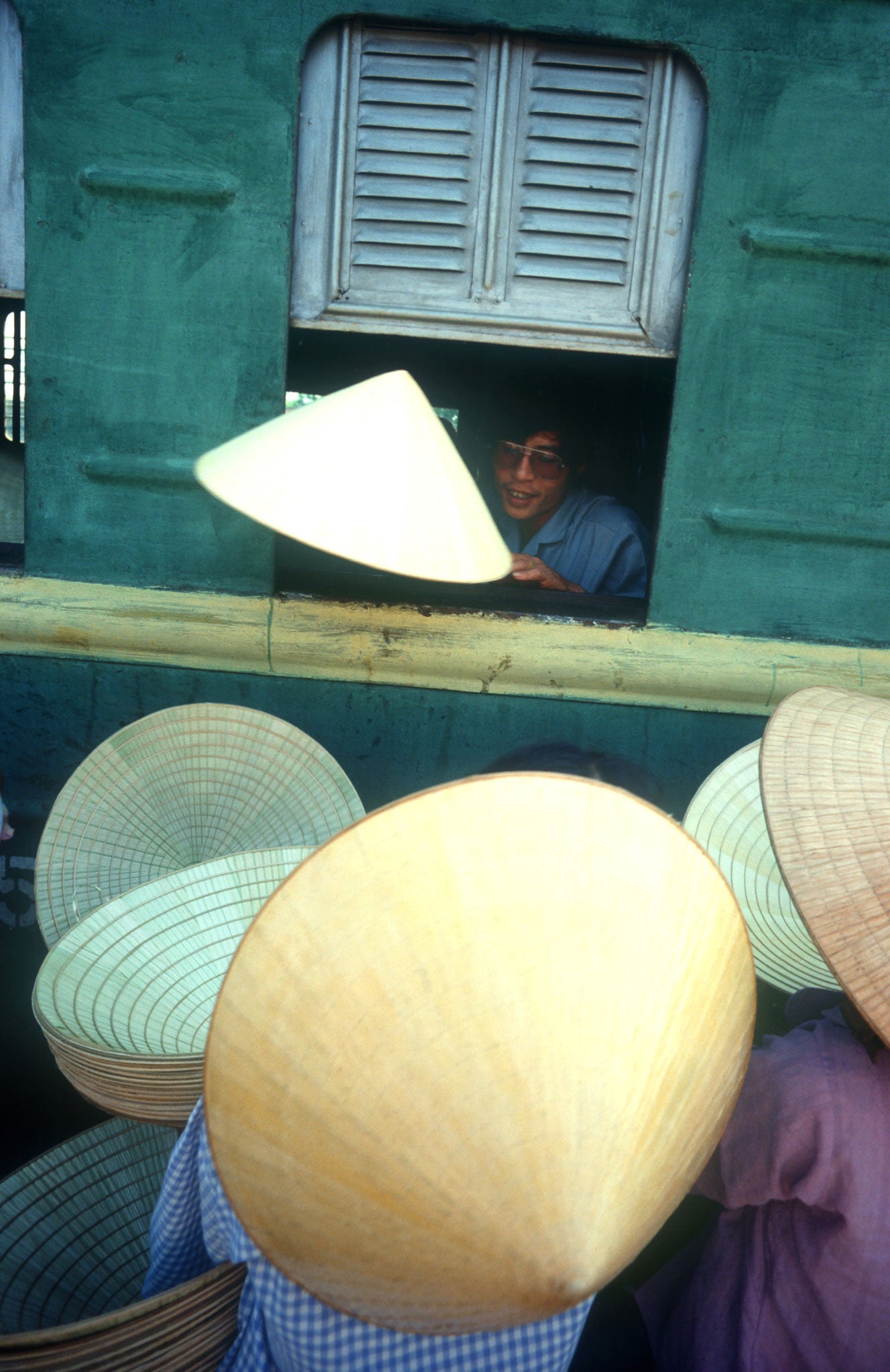 Window of opportunity: Hat sellers outside a train in Hue