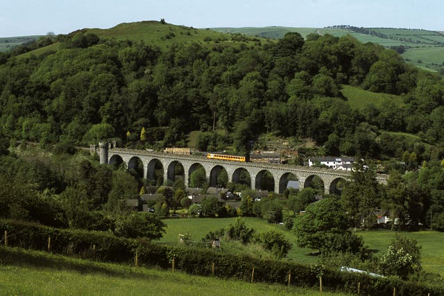 Green tracks of home: A train crosses the Knucklas Viaduct in Powys, Wales