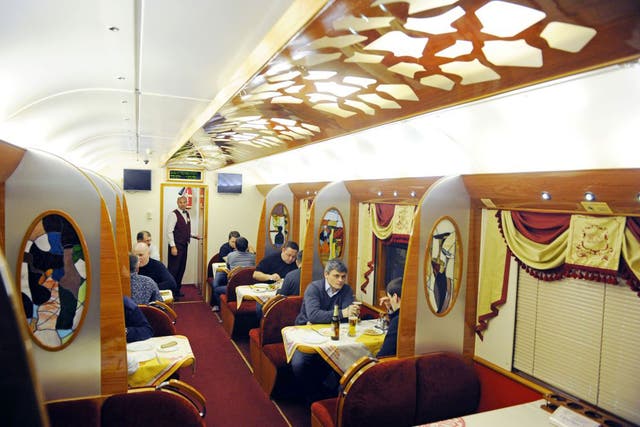 Passengers dine in the restaurant car of the Red Arrow to St Petersburg