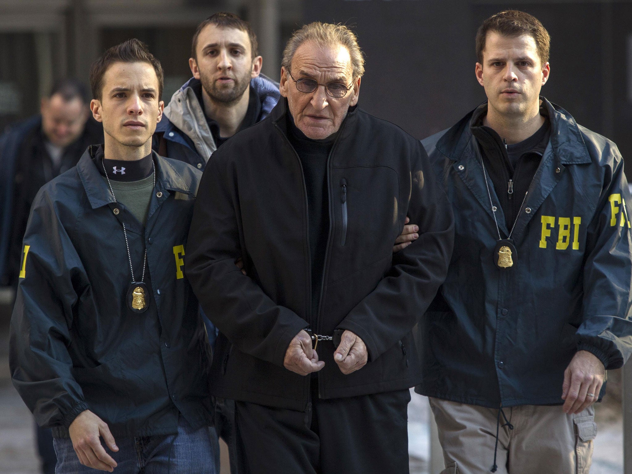 Bonanno crime family leader Vincent Asaro is escorted by FBI agents; the Bonanno crime family committed acts of extortion and arson, including the airport heist, a brazen crime made famous by the 1990 film 'Goodfellas'
