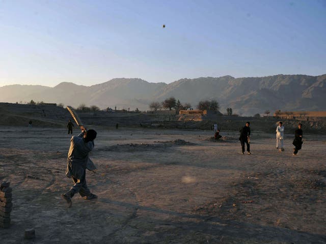 Afghan children play cricket on the outskirts of Jalalabad, Nangarhar province, near to Alinghar, Laghman where the cricket players were shot by a gunman.