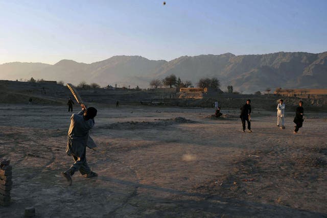 Afghan children play cricket on the outskirts of Jalalabad, Nangarhar province, near to Alinghar, Laghman where the cricket players were shot by a gunman.