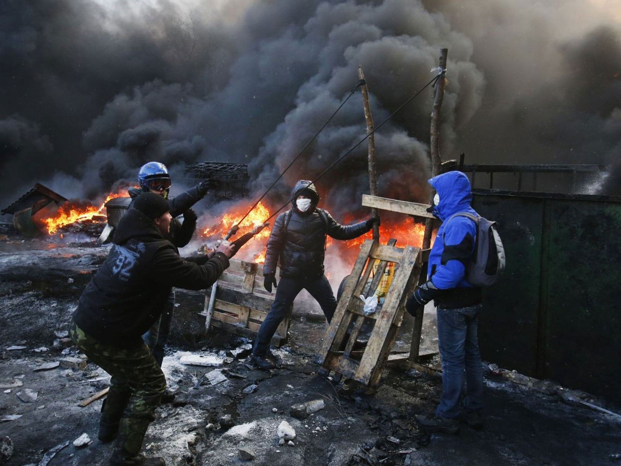 Thick black smoke from burning tires engulfed parts of downtown Kiev as an ultimatum issued by the opposition to the president to call early election or face street rage was set to expire with no sign of a compromise