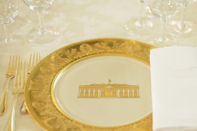 A table setting is shown during a press preview of the State dinner for Queen Elizabeth II of England and her husband Prince Philip 07 May 2006 in the State Dining Room of the White House in Washington, DC.