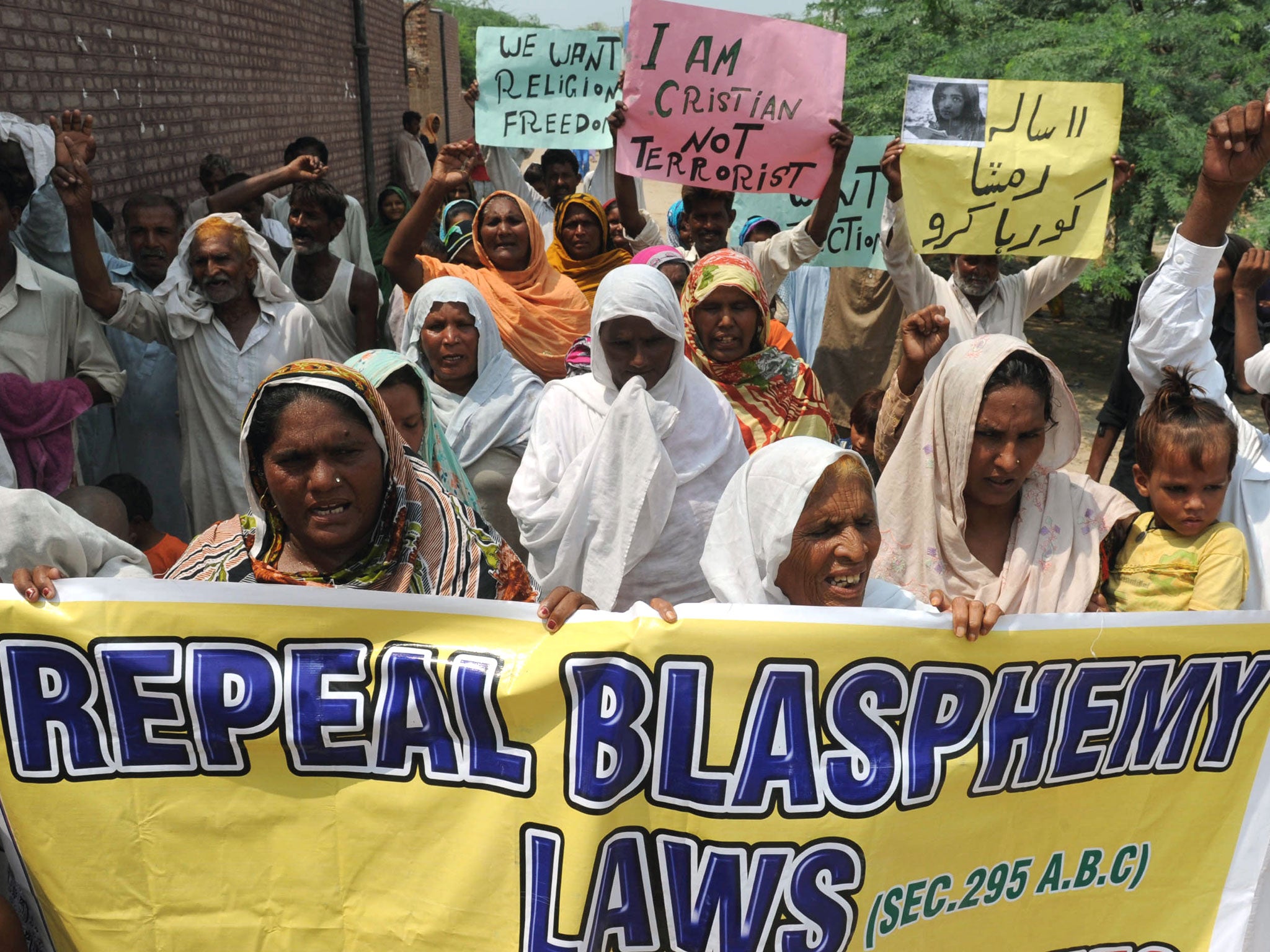 Pakistani Christian villagers march during a protest against the country's strict blasphemy laws against Islam in Korian