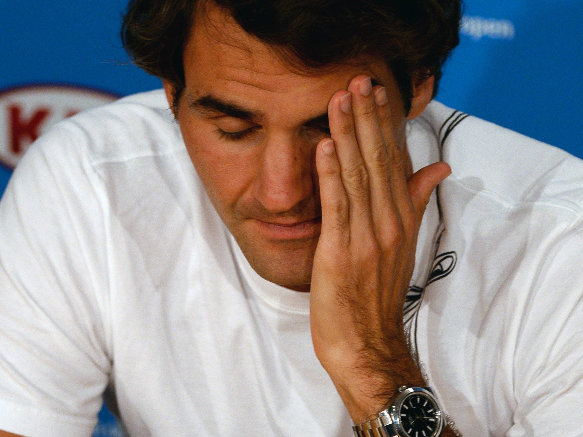 Roger Federer talks to the press following his semi-final defeat to Nadal