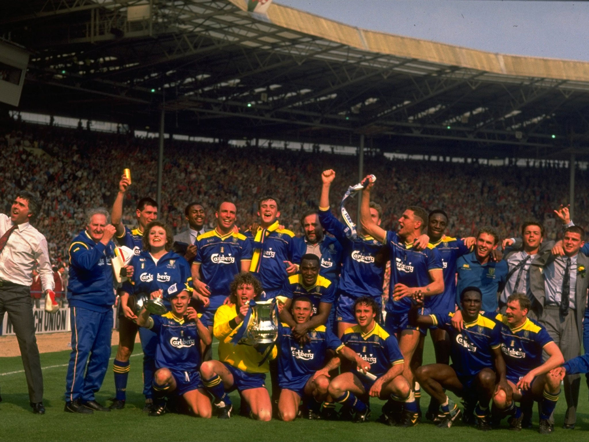 May 1988: The Wimbledon team celebrate with the trophy after the FA Cup final against Liverpool