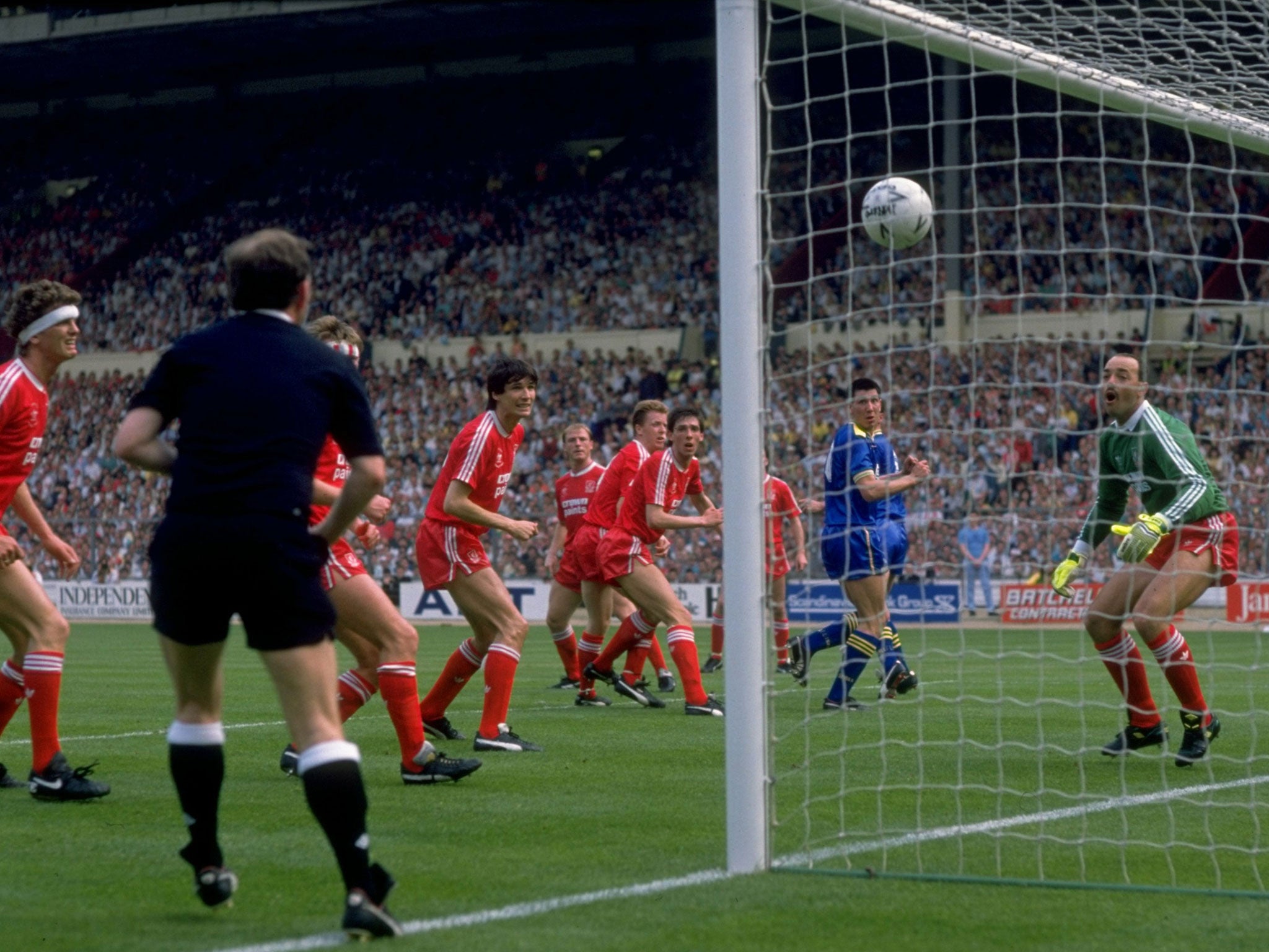 1988: Lawrie Sanchez of Wimbledon beats Liverpool goalkeeper Bruce Grobbelaar to score the winning goal (Getty)