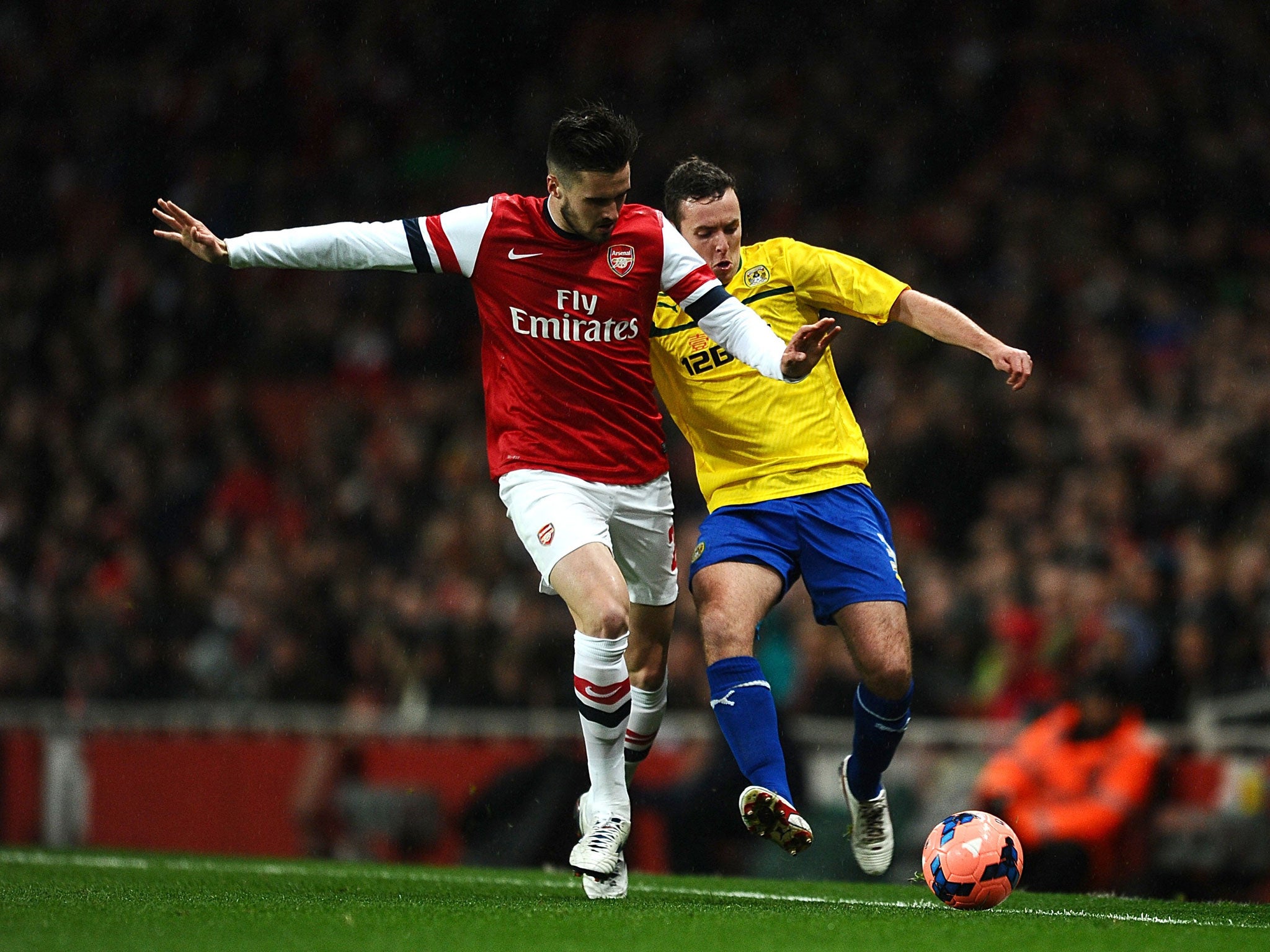 Coventry City's Blair Adams (right) and Arsenal's Carl Jenkinson battle for the ball