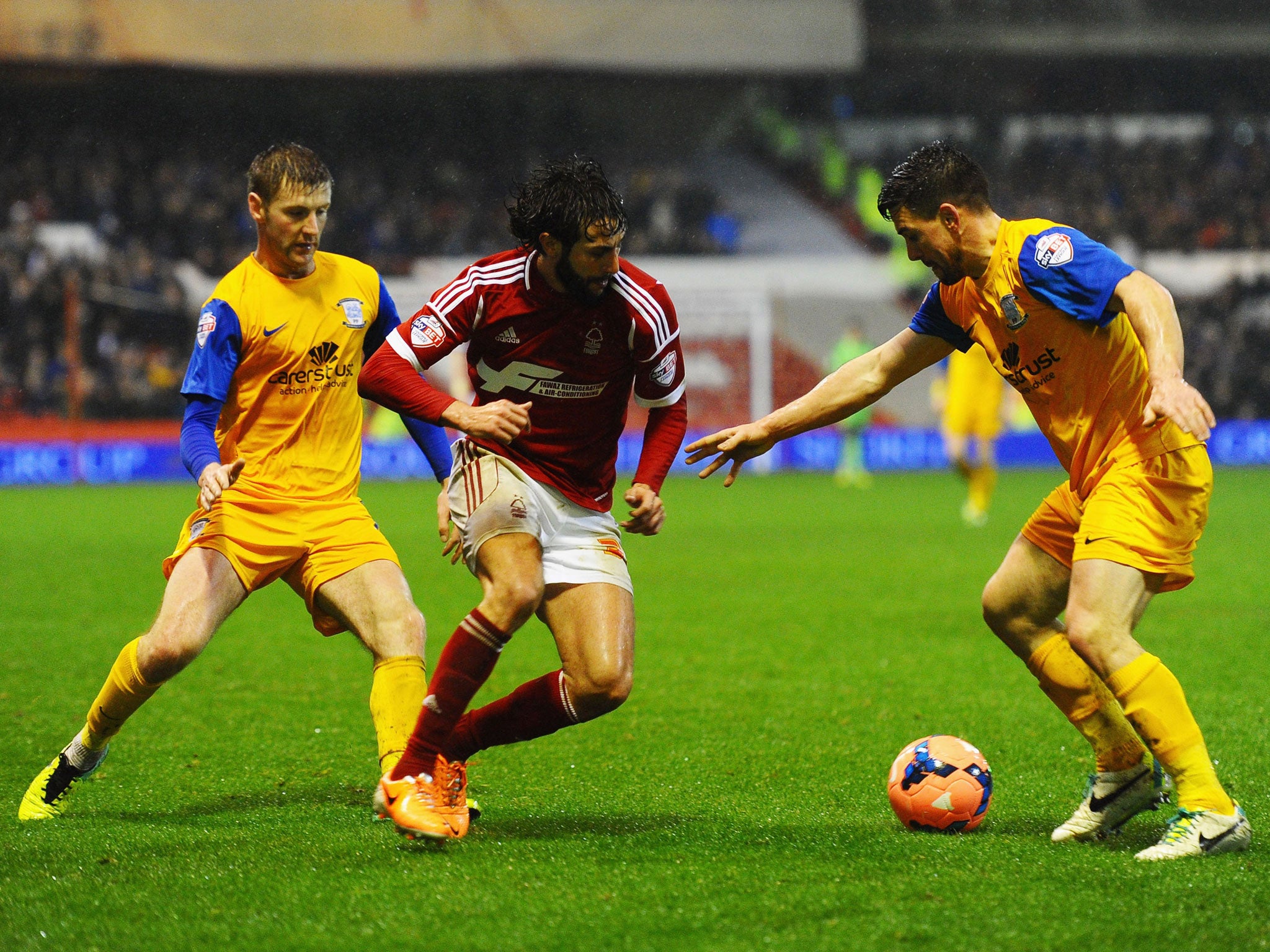 Djamel Abdoun of Nottingham Forest, centre, takes on Paul Gallagher, left, and David Buchanan of Preston North End