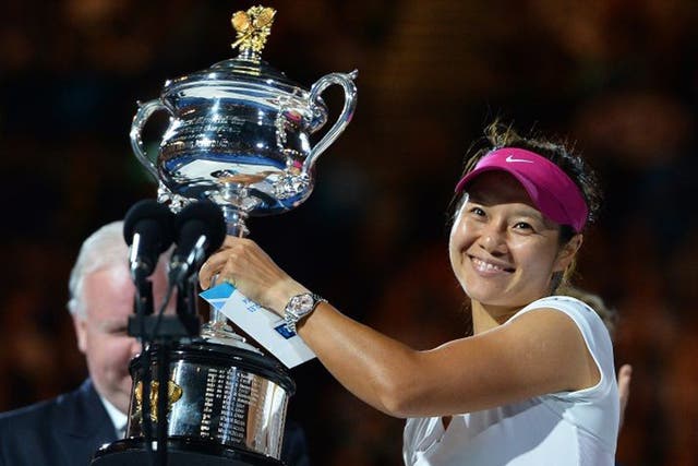 China's Li Na poses with the trophy after her victory against Slovakia's Dominika Cibulkova during the women's singles final at the 2014 Australian Open tennis tournament in Melbourne