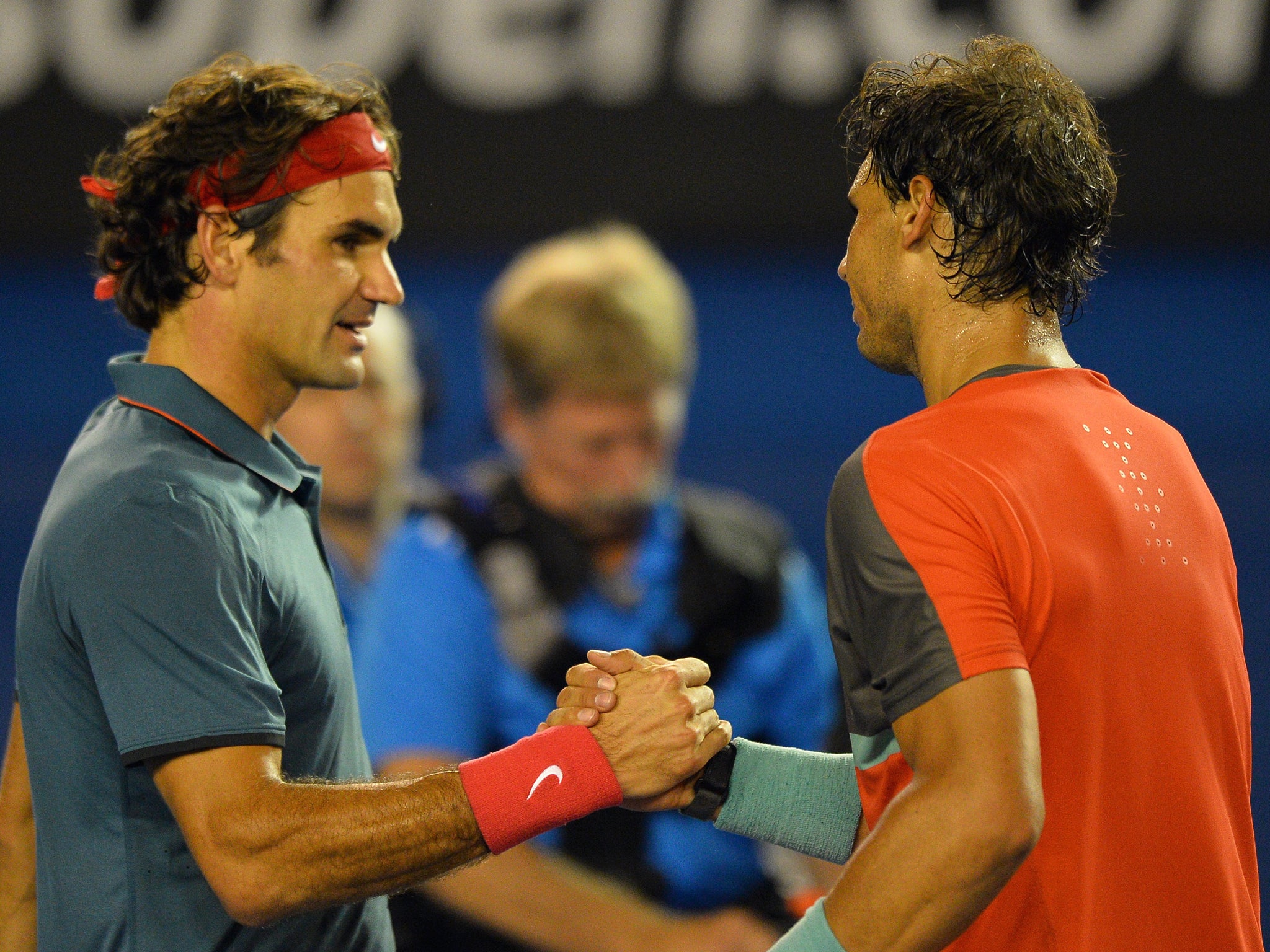 Roger Federer and Rafael Nadal shake hands after the latter progresses to the Australian Open final
