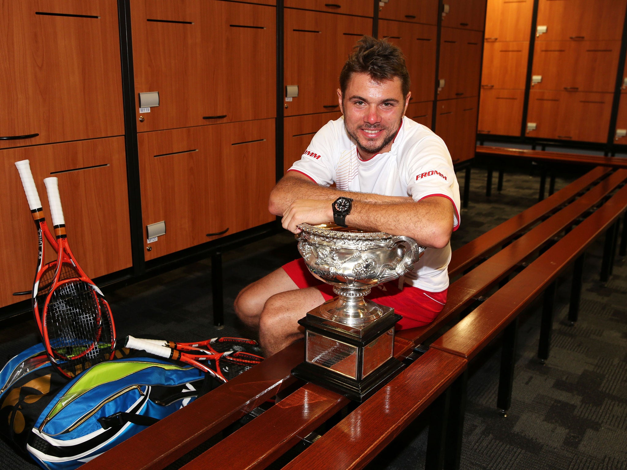 Switzerland's Stanislas Wawrinka poses with the Norman Brookes Challenge Cup in the players dressing room after winning his men's final match against Rafael Nadal