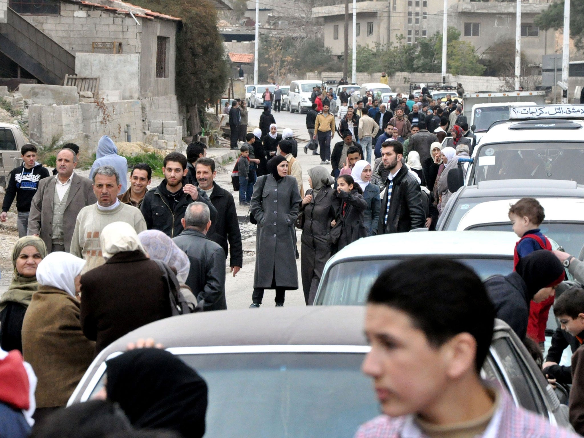 Families, who had fled their homes due to fighting, return to their houses in the Barzeh neighbourhood of Damascus