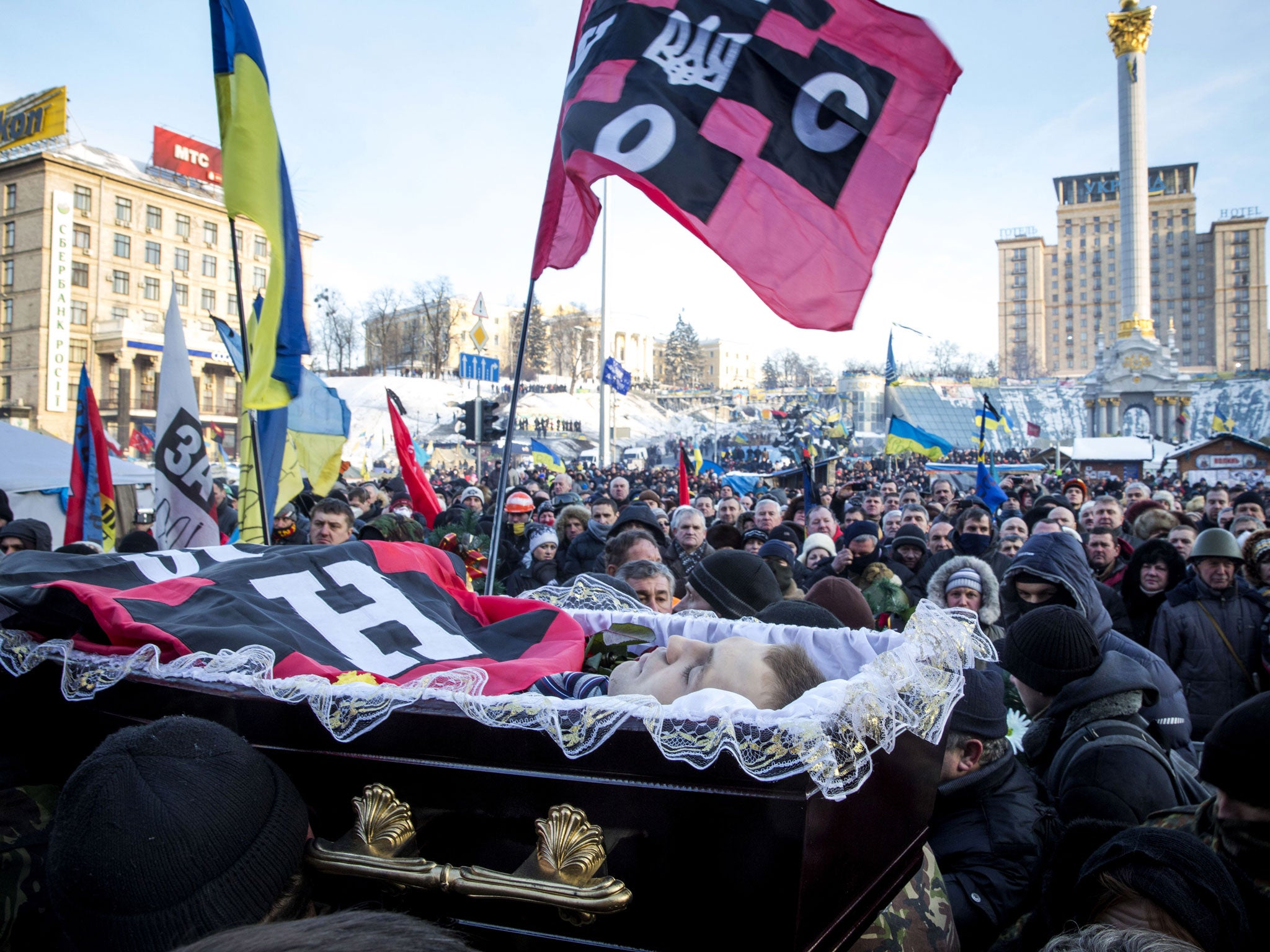 Anti-government protesters carry the body of Mikhail Zhiznevsky, 25, a protester killed during clashes with police on Wednesday(Getty Images)