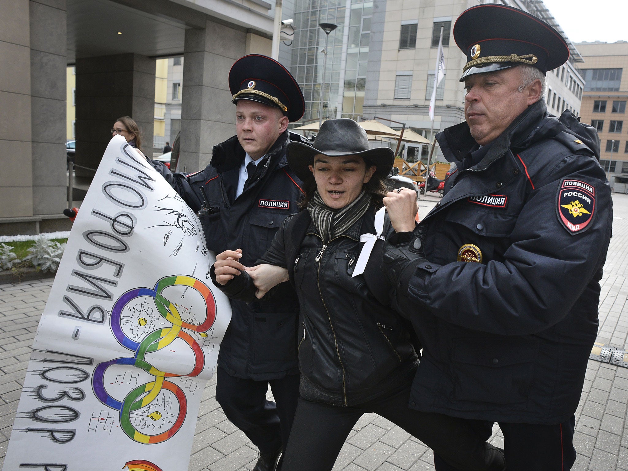 Police officers detain a gay rights activist during a protest outside the headquarters for the Sochi 2014 Organising Committee in Moscow