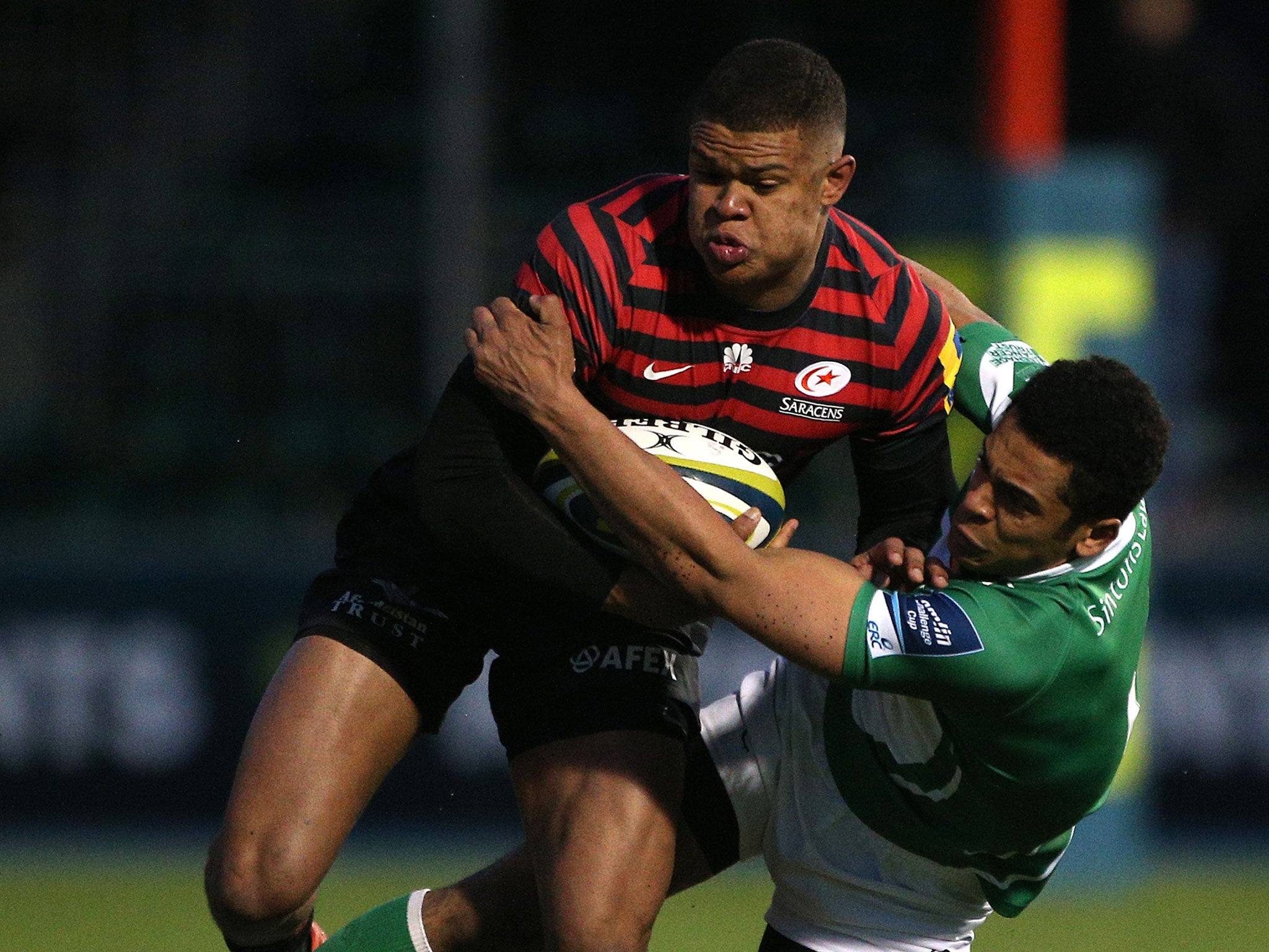 Saracens' Nathan Earle is held by Zach Kibirige during the game on Sunday