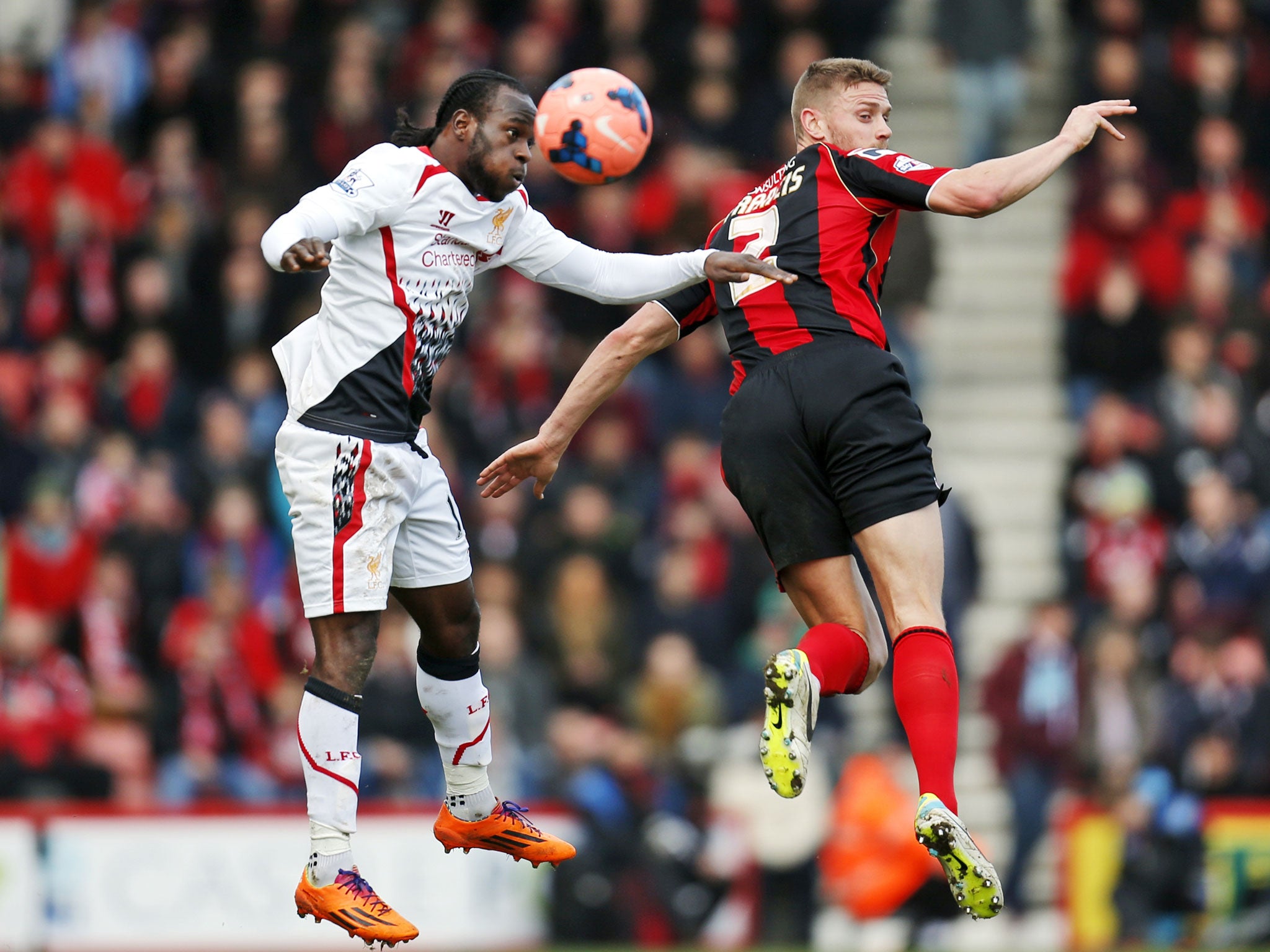 Liverpool's Victor Moses, left, fights for the ball with AFC Bournemouth's Simon Francis