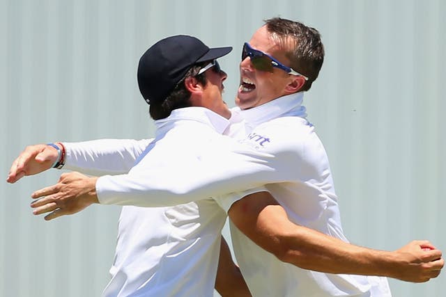 Alastair Cook and Graeme Swann celebrate during the 2013-14 Ashes Series in Australia
