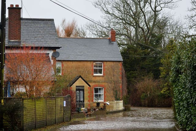 Flood water surrounds houses in the village of Thorney in Somerset, southwest England, on January 26, 2014. A local council delcared a major incident on the flood-hit Somerset Levels where some villages like Muchelney have been cut off for weeks by floodi