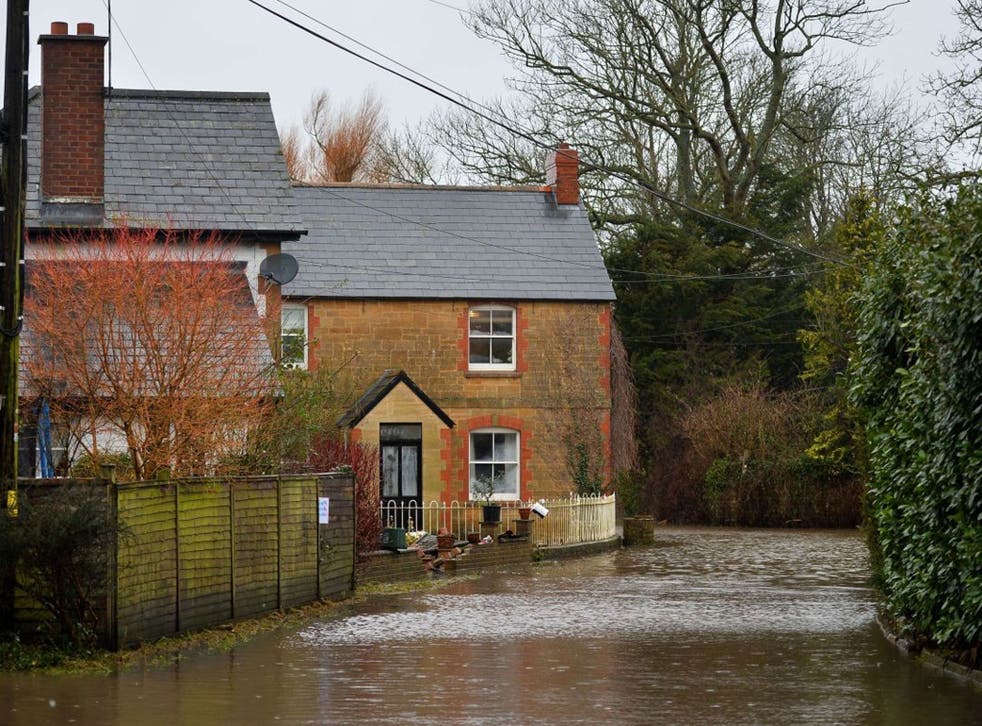 Flood water surrounds houses in the village of Thorney in Somerset, southwest England, on January 26, 2014. A local council delcared a major incident on the flood-hit Somerset Levels where some villages like Muchelney have been cut off for weeks by floodi