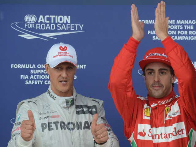 Michael Schumacher and Fernando Alonso pose together