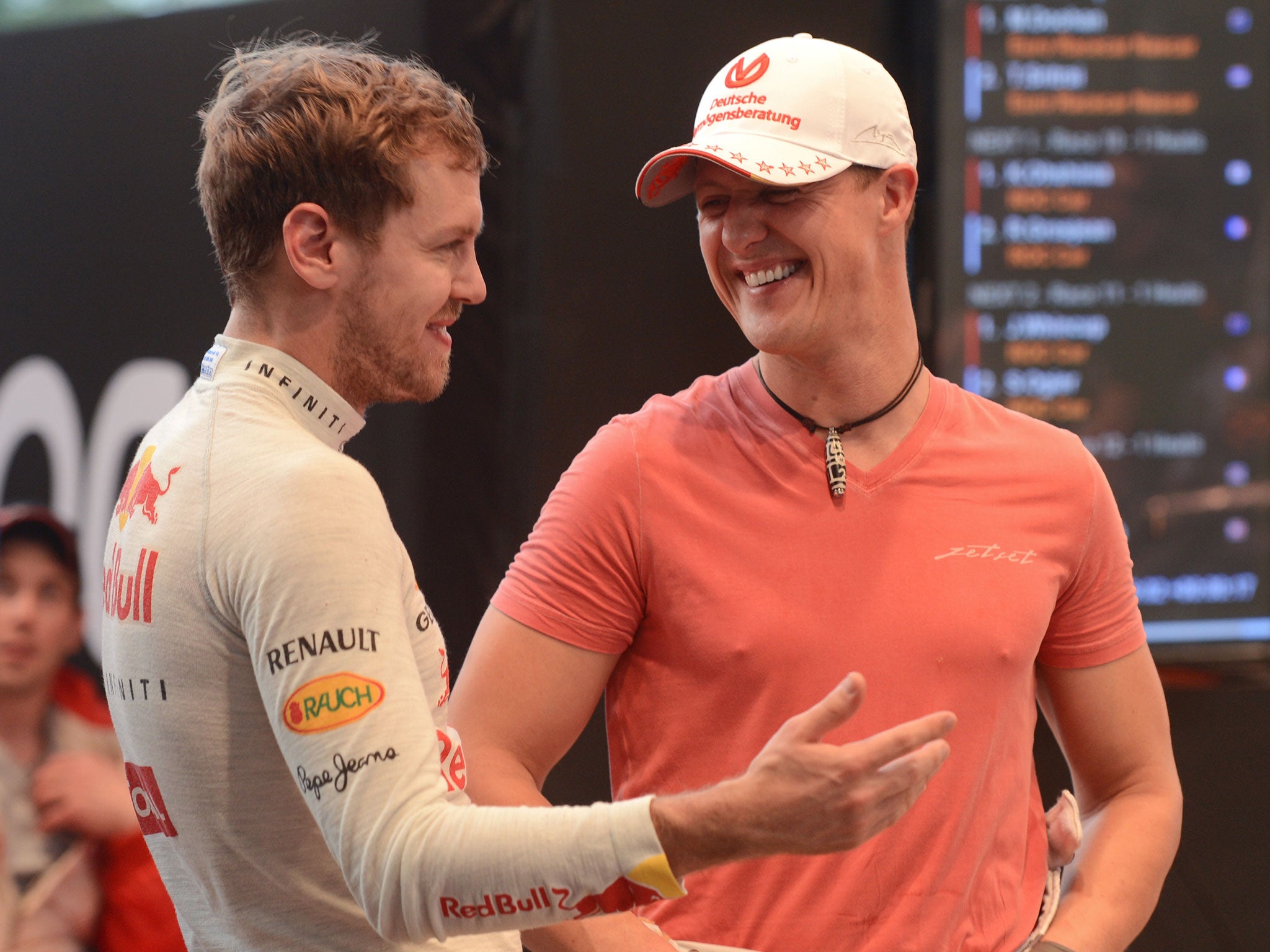 Sebastian Vettel and Michael Schumacher share a joke during the 2012 Race of Champions in Bangkok