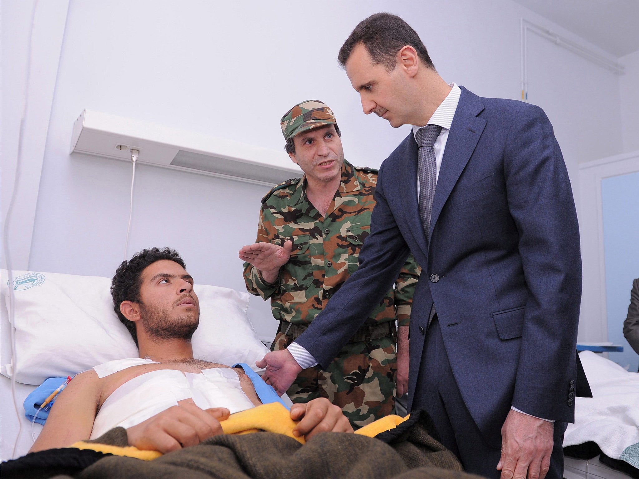 Syrian President Bashar Assad visits army and security soldiers wounded in the civil war at al-Youssef al-Azmah Hospital in Damascus