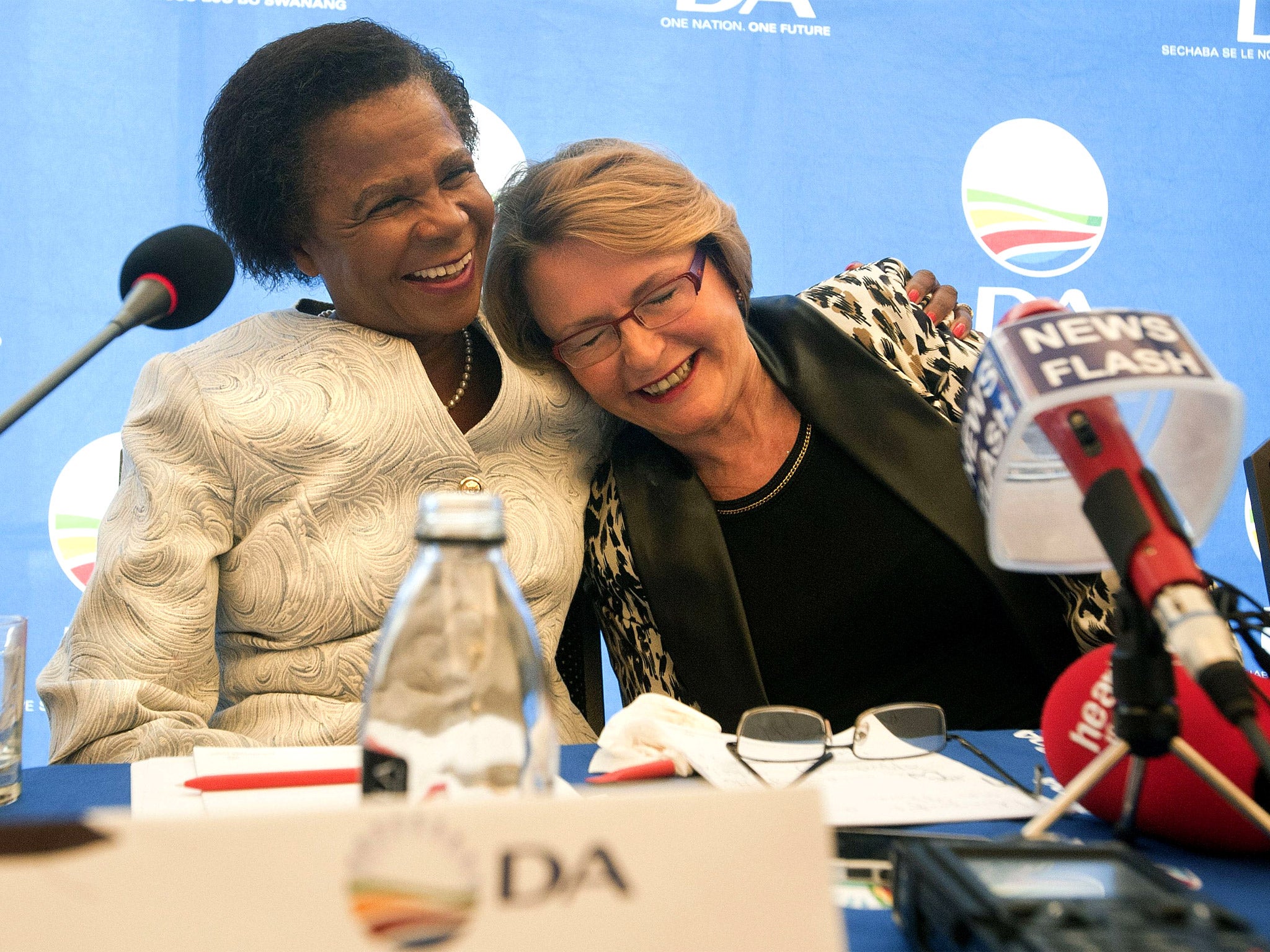 Helen Zille (right), leader of the Democratic Alliance, is hugged by Mamphela Ramphele at the Cape Town conference