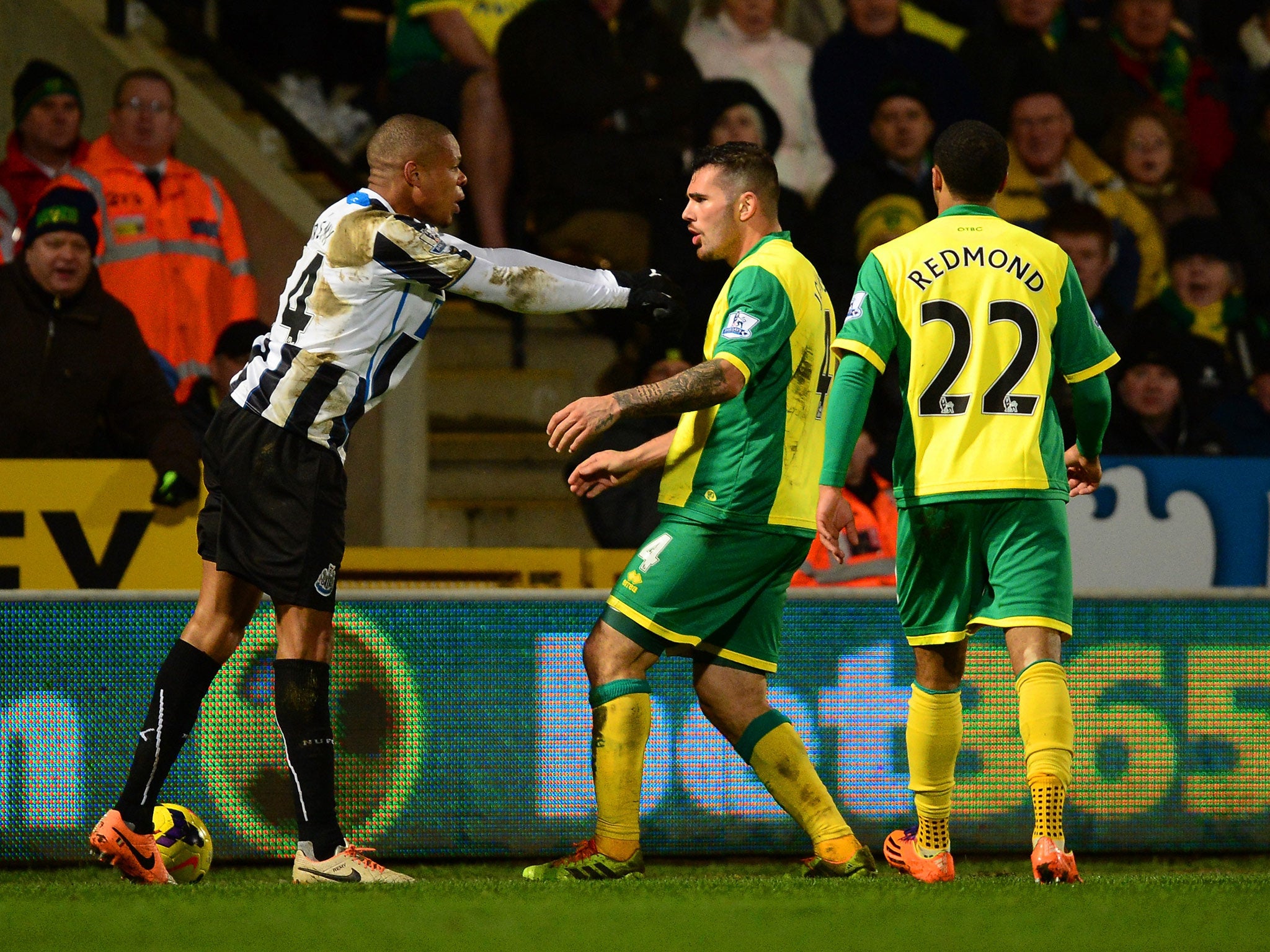 Loic Remy of Newcastle United and Bradley Johnson of Norwich City come to blows