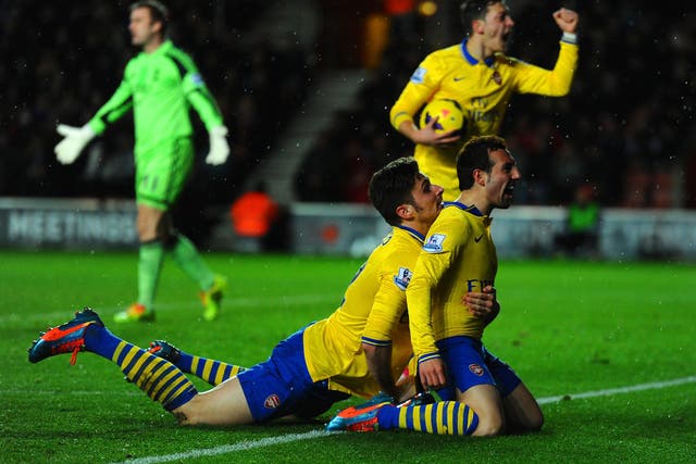 Santi Cazorla of Arsenal celebrates scoring their second goal with Olivier Giroud 