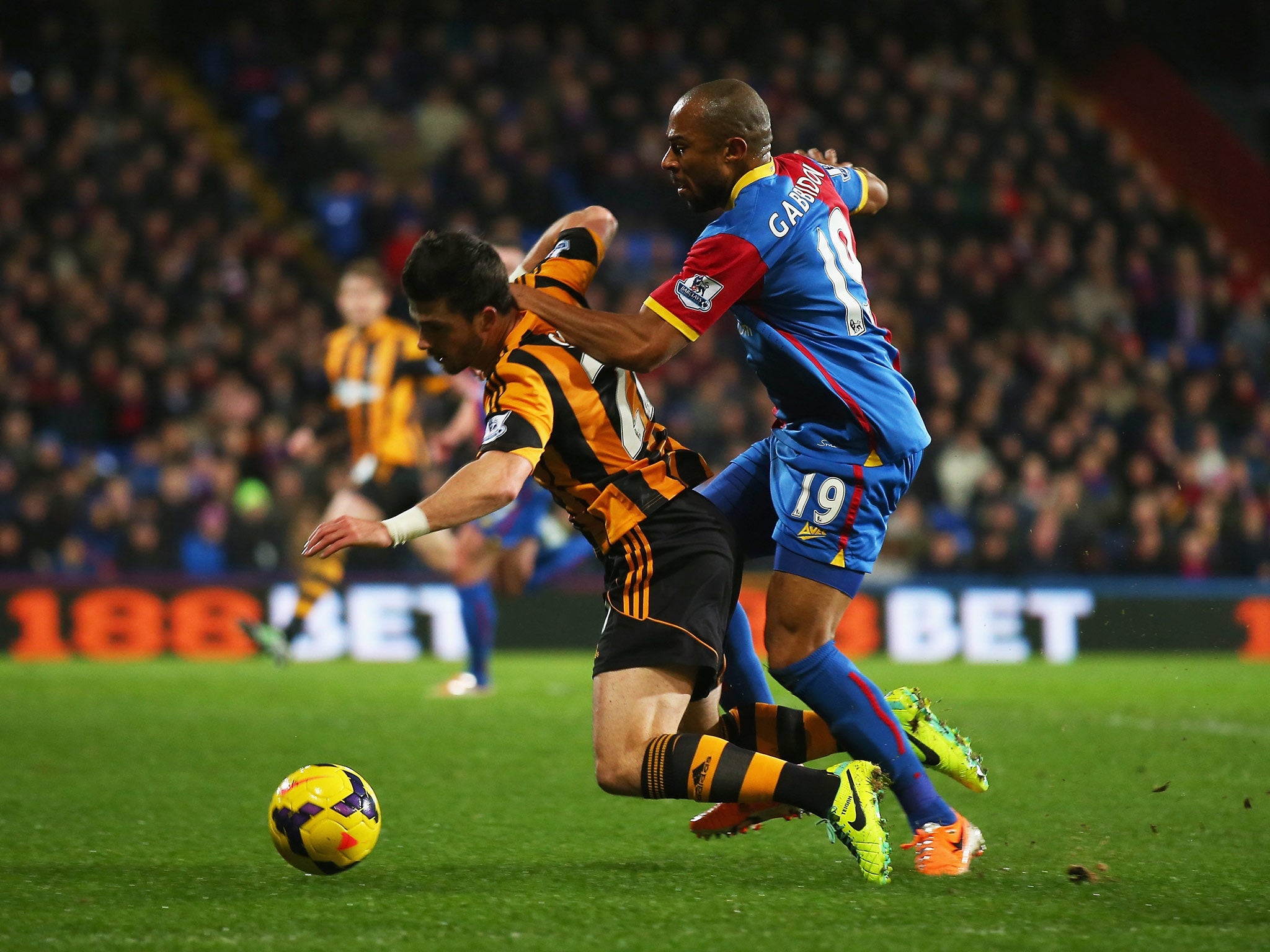 Shane Long of Hull City goes to ground after a challenge by Danny Gabbidon of Crystal Palace