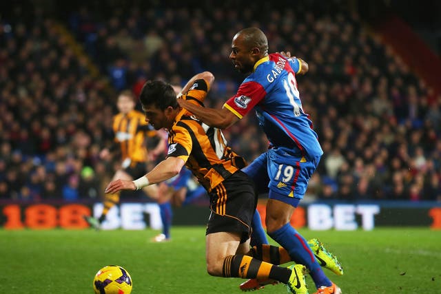 Shane Long of Hull City goes to ground after a challenge by Danny Gabbidon of Crystal Palace