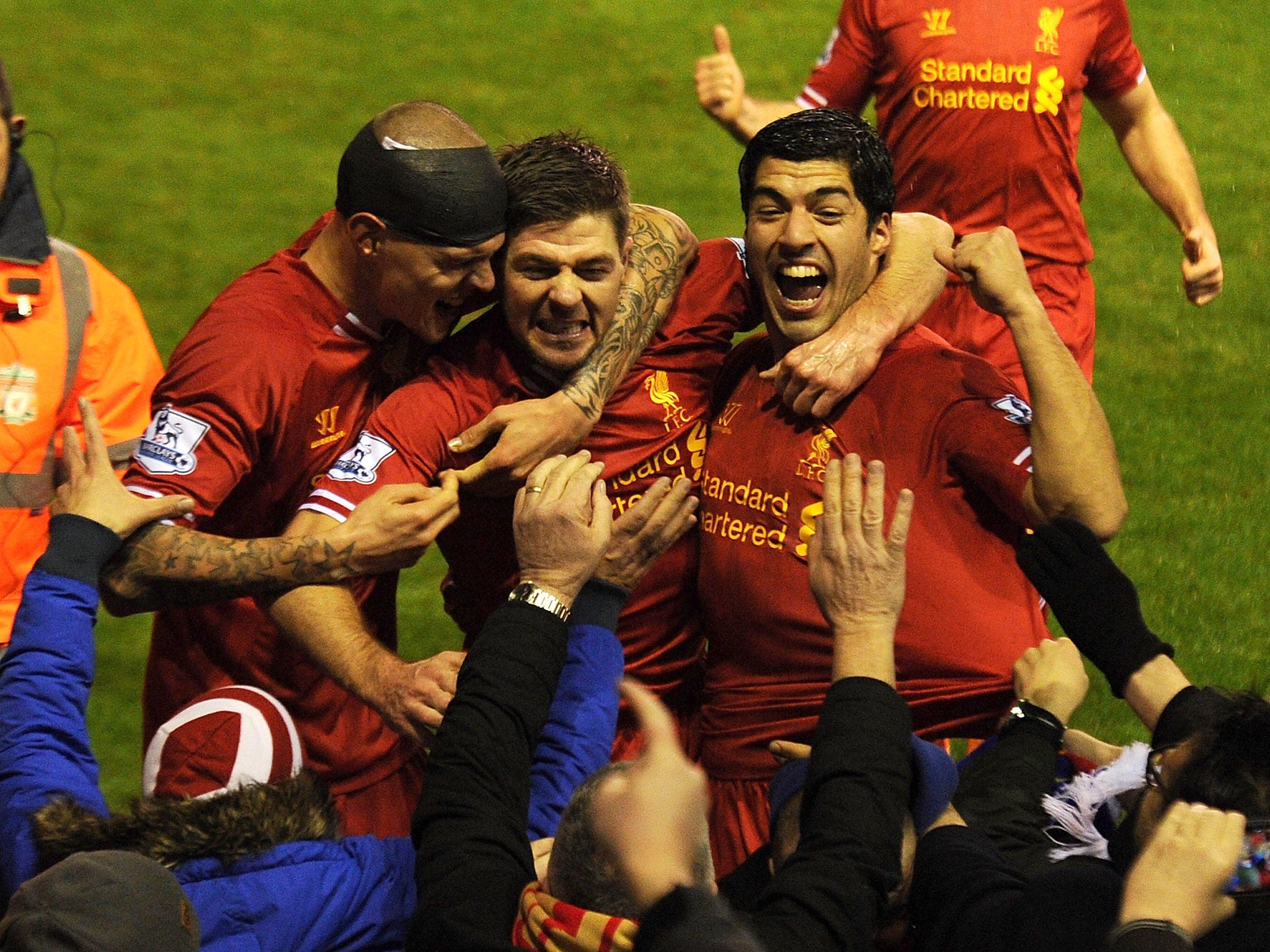 Steven Gerrard of Liverpool celebrates his goal with Martin Skrtel and Luis Suarez
