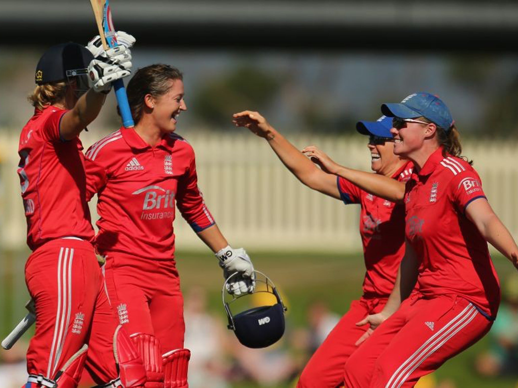 Sarah Taylor and Charlotte Edwards celebrate with teammates after winning the match and retaining the Ashes in Hobart