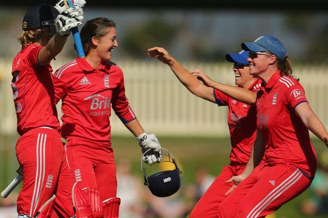 Sarah Taylor and Charlotte Edwards celebrate with teammates after winning the match and retaining the Ashes in Hobart