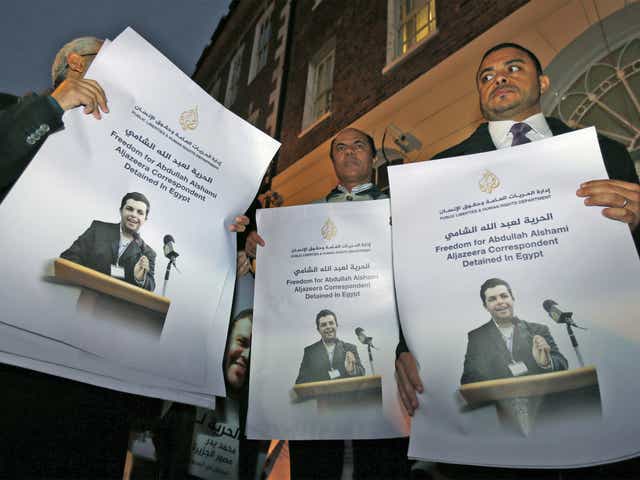 Demonstrators hold placards with pictures of Al-Jazeera journalist Abdullah Al Shami who - along with cameraman Mohammed Badr - remains in custody in Egypt, during a protest outside Egypt's embassy in London last November
