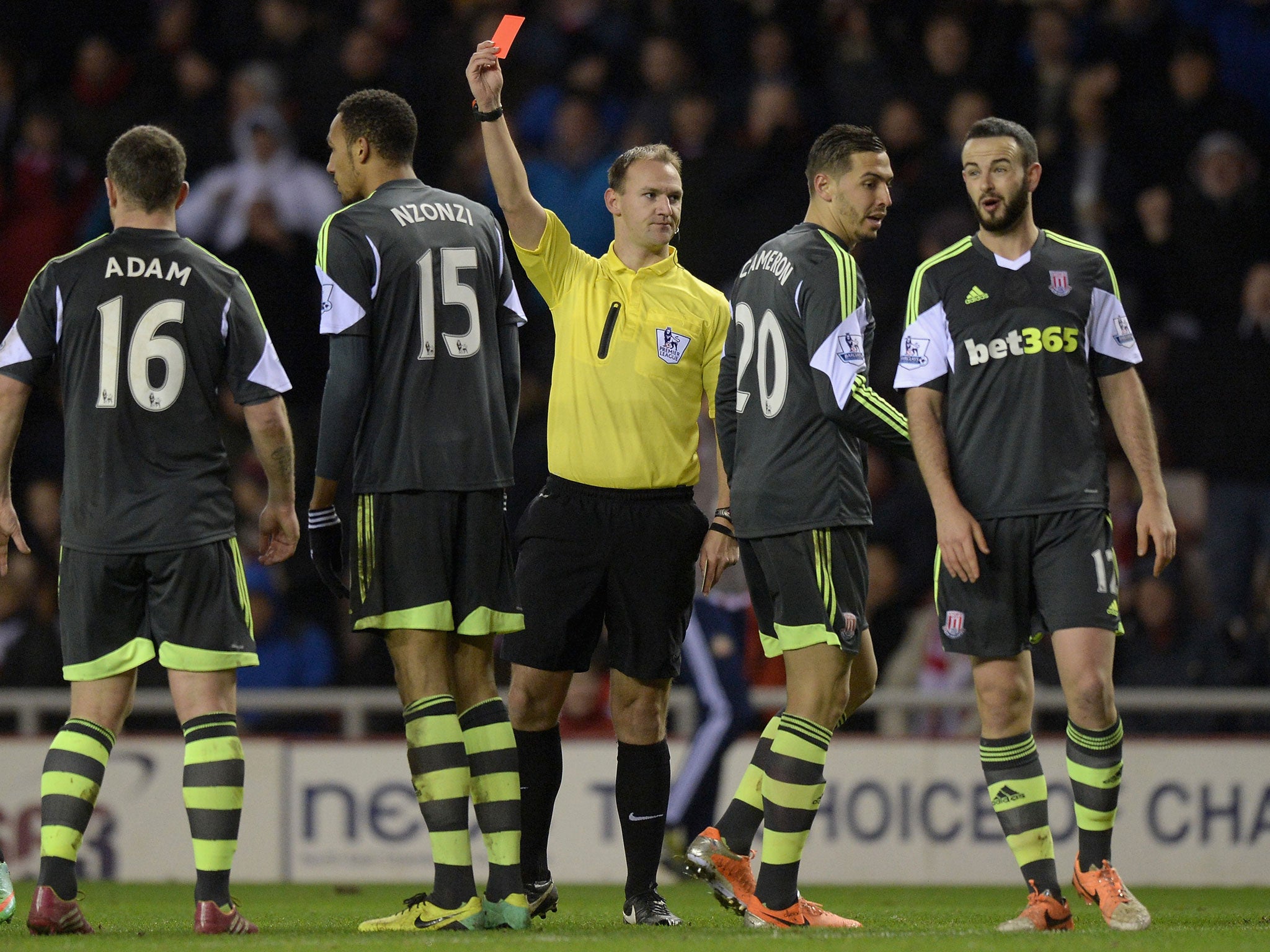 Steven N'Zoni of Stoke City is sent off by referee Robert Madley