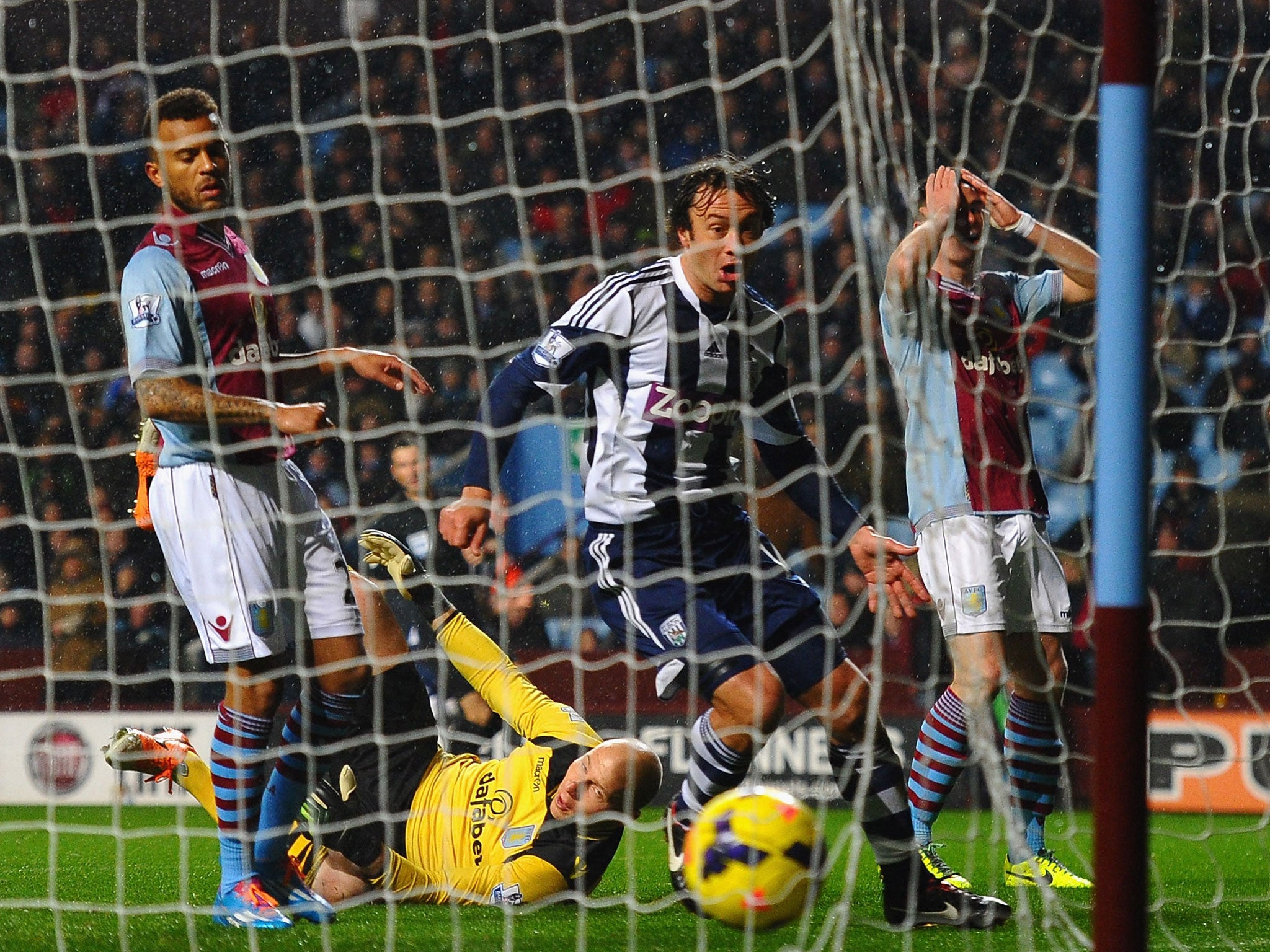 Fabian Delph of Aston Villa scores an own goal past Brad Guzan